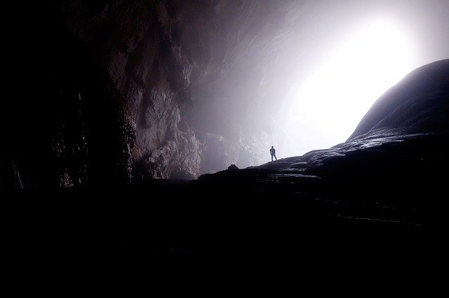 Person in cave with white light