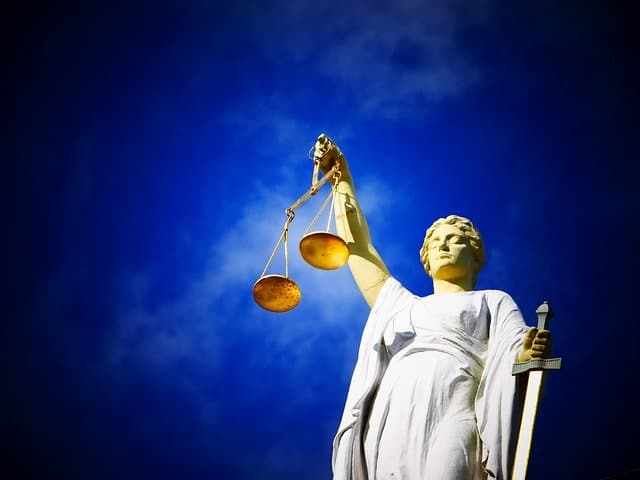 Justice scales in front of a blue sky.